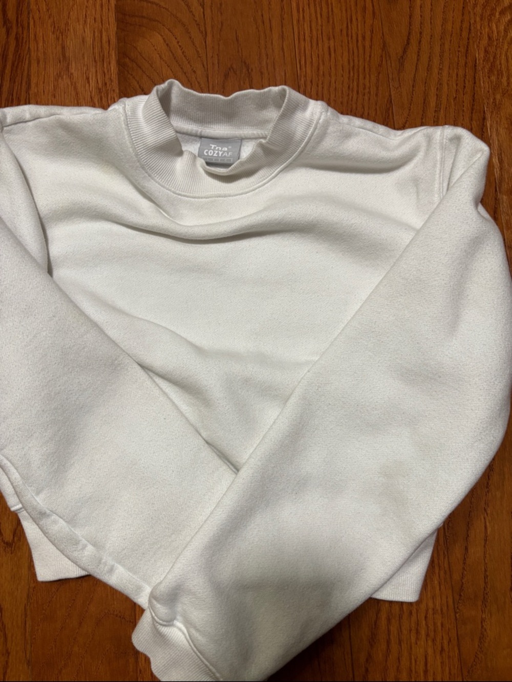 TNA Cozyaf Fleece Crewneck in White with Gray Label